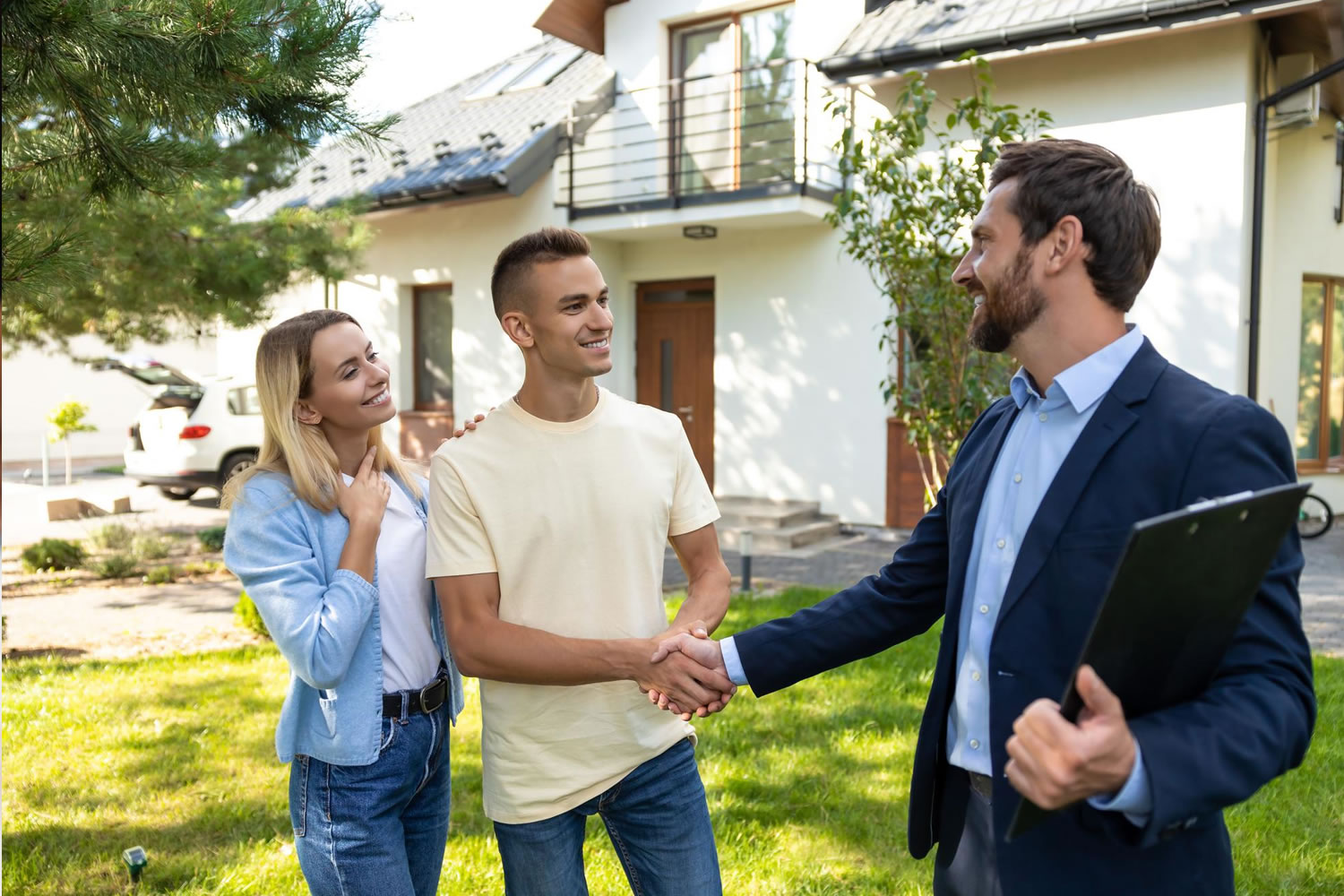 Couple holding small house medium shot